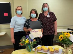 Congratulating Julie Foster, 2022 Sunflower Award winner, are Jackie Kernan, president (left), and Julia Geiger, Environmental Services supervisor (right)