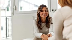 close-up-of-smiling-woman-talking-to-a-friend