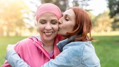 woman hugging another female breast cancer patient