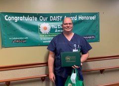 Photo of Brett Gibson accepting his DAISY Award.