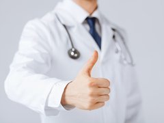 Doctor holding a thumbs up.