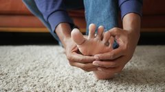 close-up-of-person-holding-foot